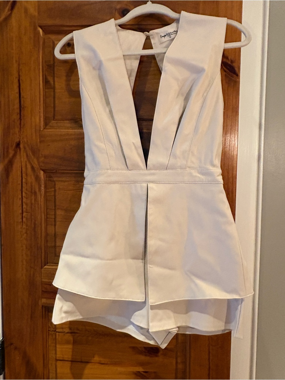 Impressions brand Ivory Deep V Peplum Romper